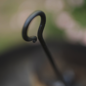 hand forged flambadou handle with curled detail