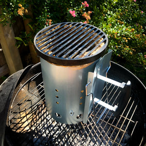 Charcoal Chimney Grill sitting on a weber kettle barbecue
