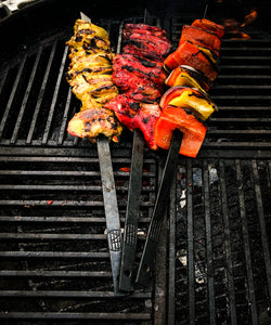 Hand forged skewers of meat and veg over charcoal 