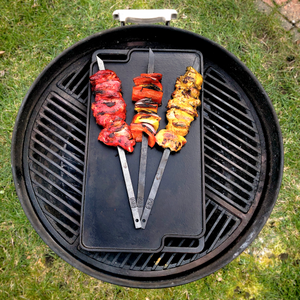Three skewers on a barbecue plancha